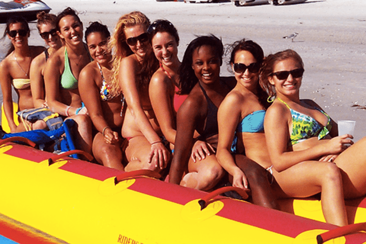 a group of people sitting at a beach