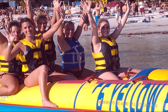 a group of people sitting at a crowded beach